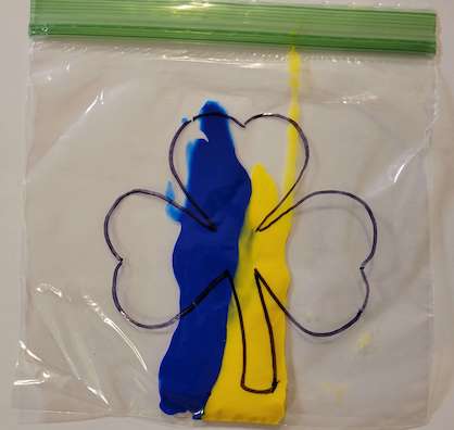 Yellow and blue paint in a bag